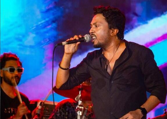 Belal Khan performing with band, stage lighting