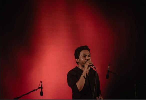 Belal Khan solo performance, red stage lighting